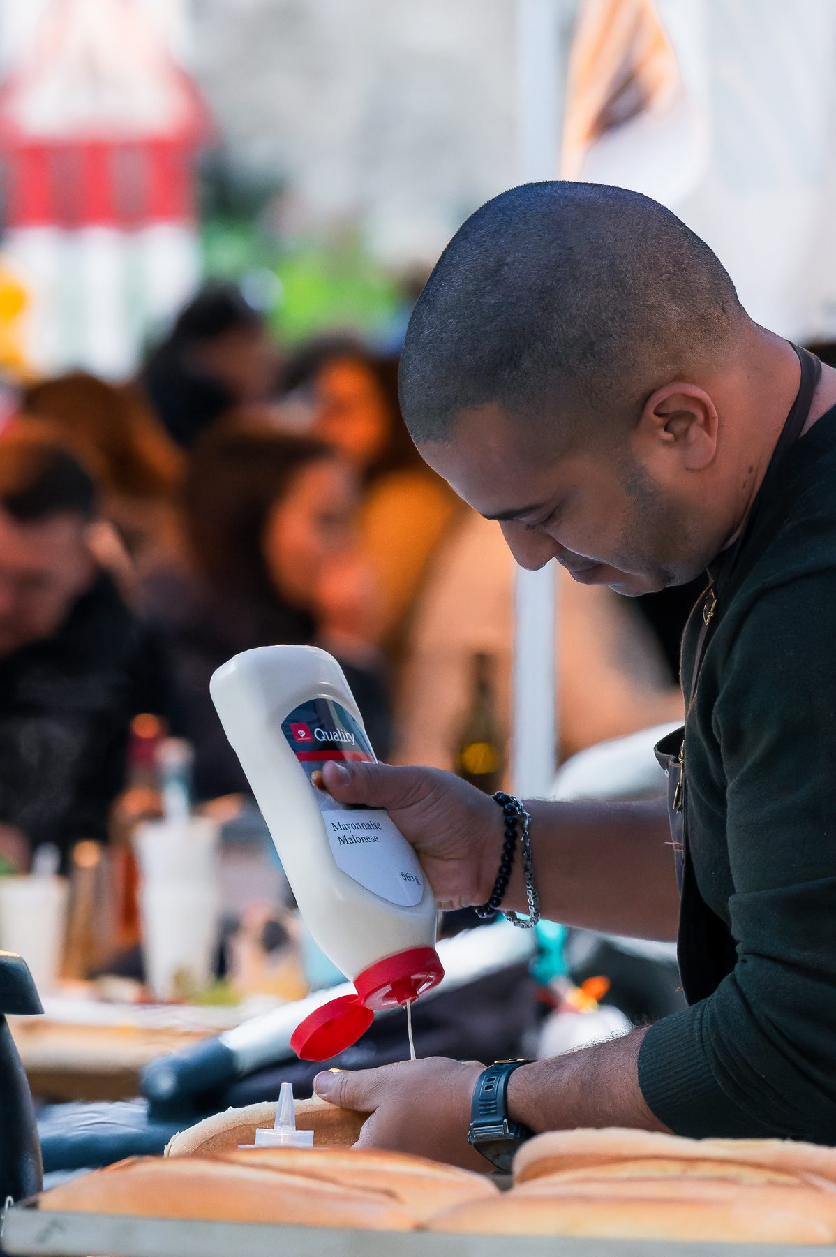 Un exposant prépare une commande sur un stand de restauration
